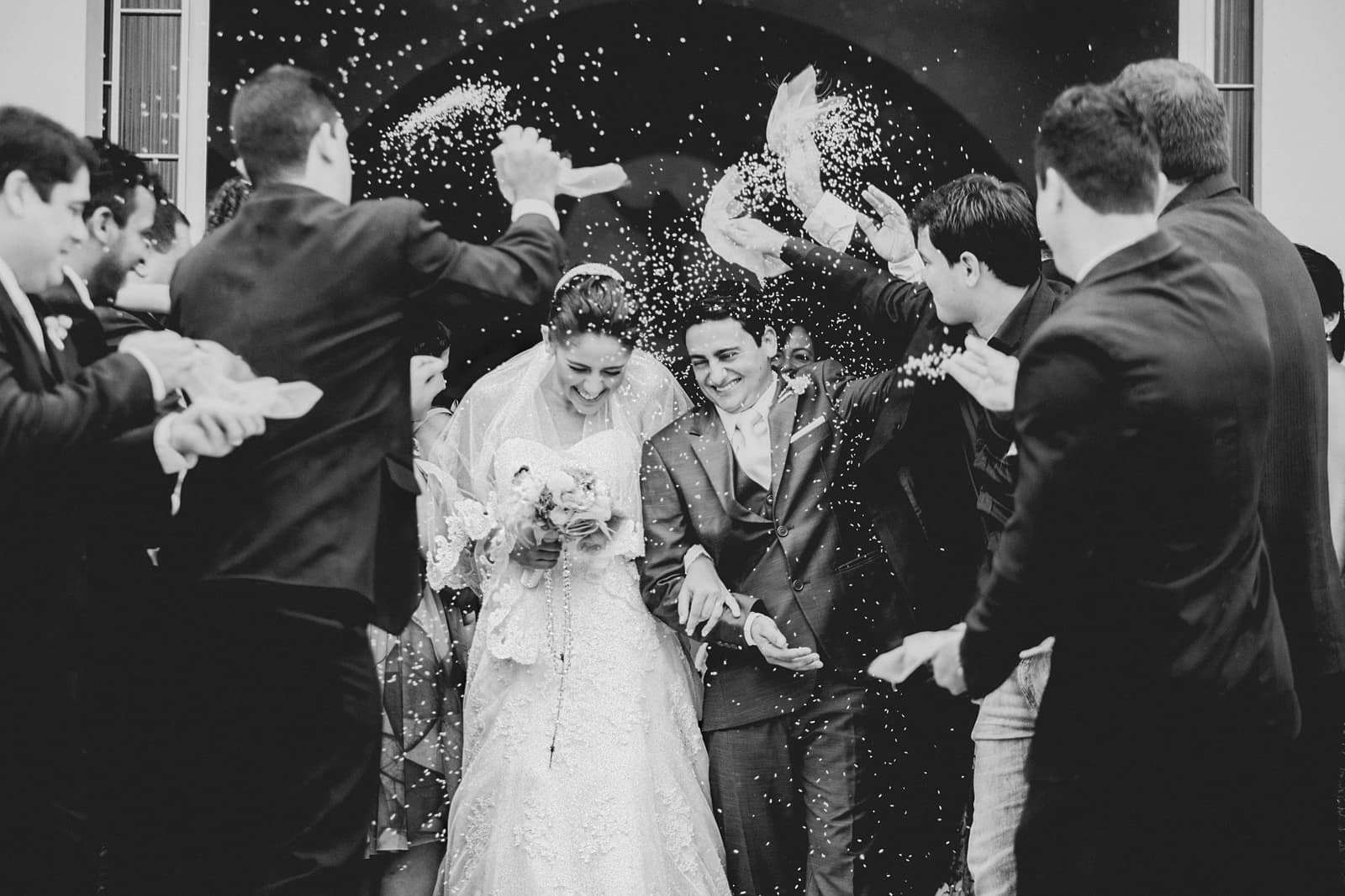 Guests showering a newly married couple with confetti
