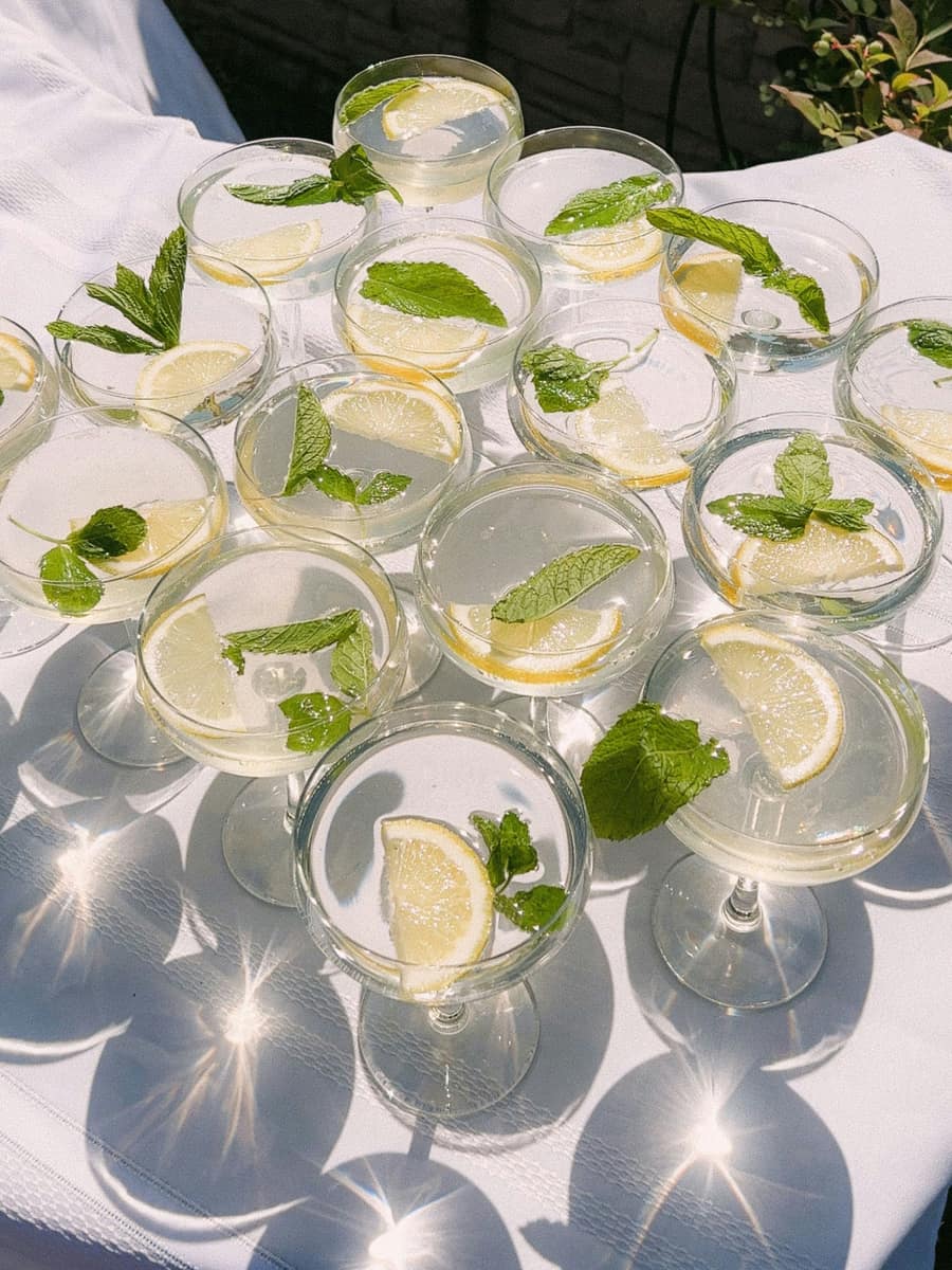 Garnished coupes arranged on a white tablecloth in the sun
